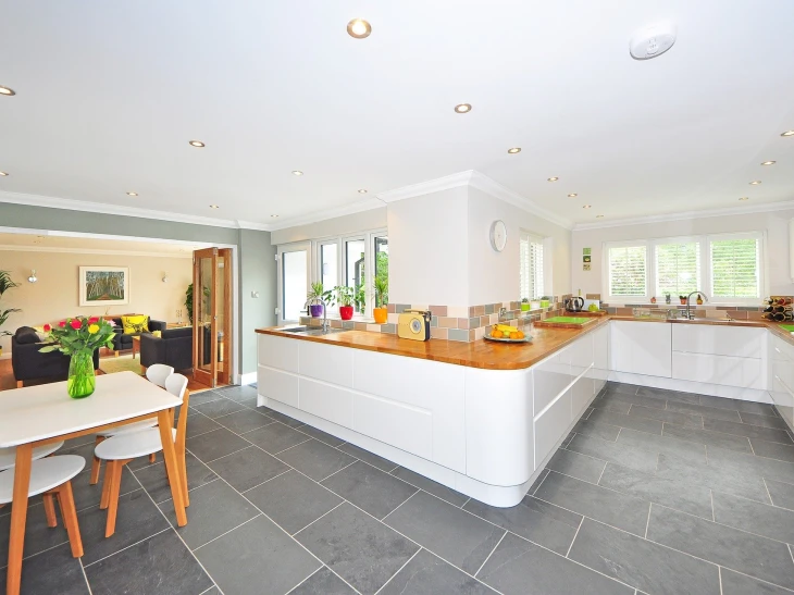 white gloss curved kitchen doors with wooden worktop