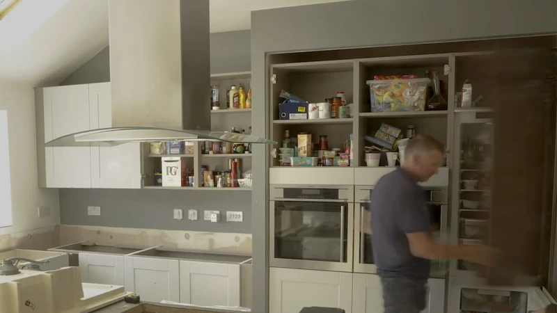 kitchen fitter working in kitchen