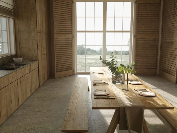 Kitchen interior, wooden furniture with dining table set in front of French doors